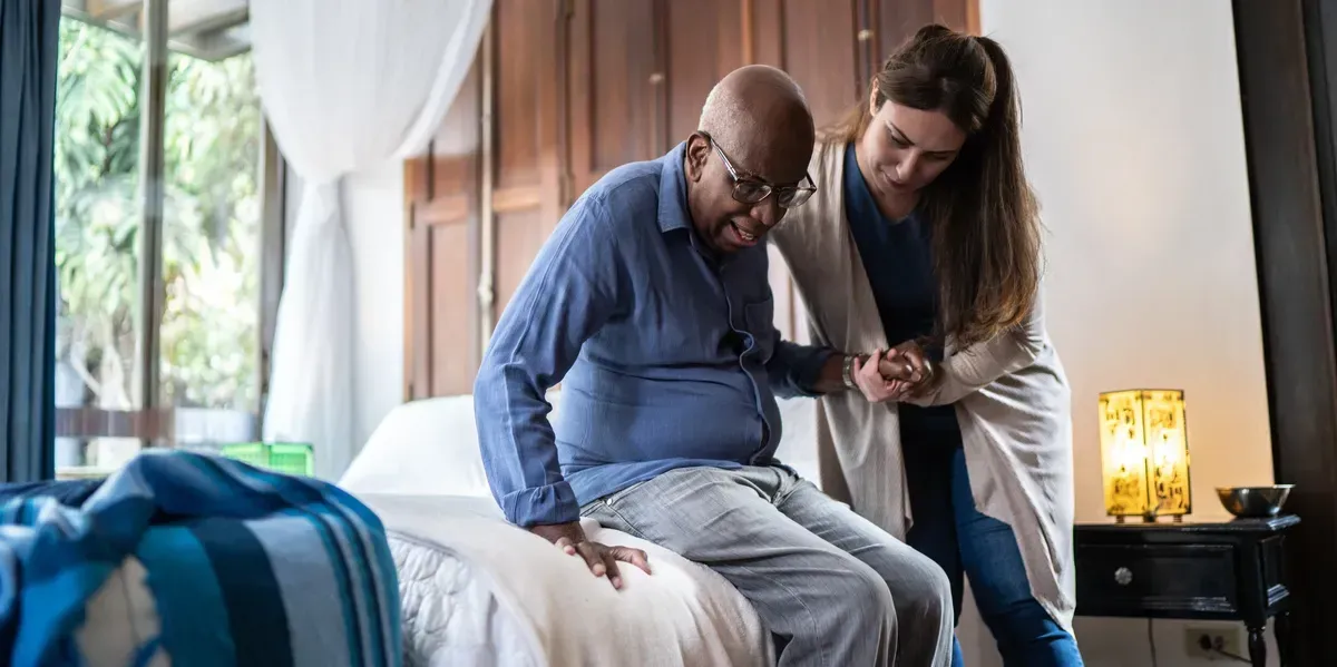 Caregiver supporting an older adult at home