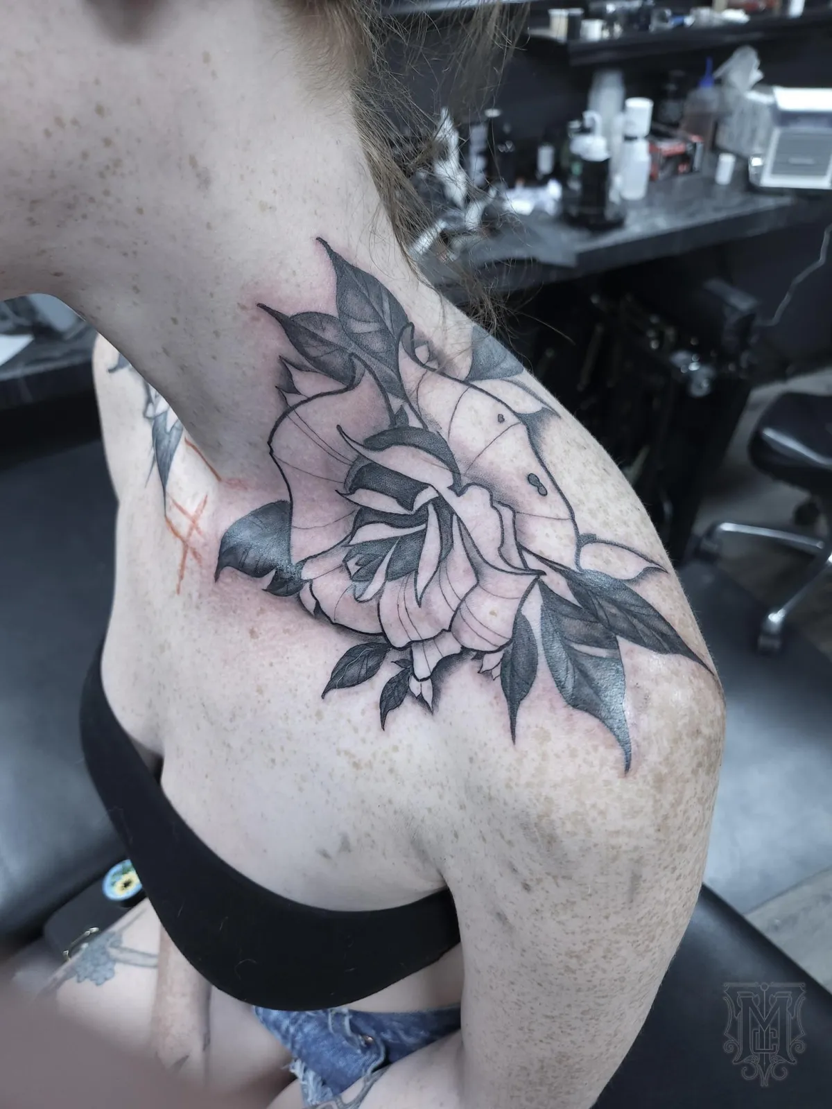 Black and grey rose shoulder and upper chest tattoo by Mickey Schlick in Missoula Montana