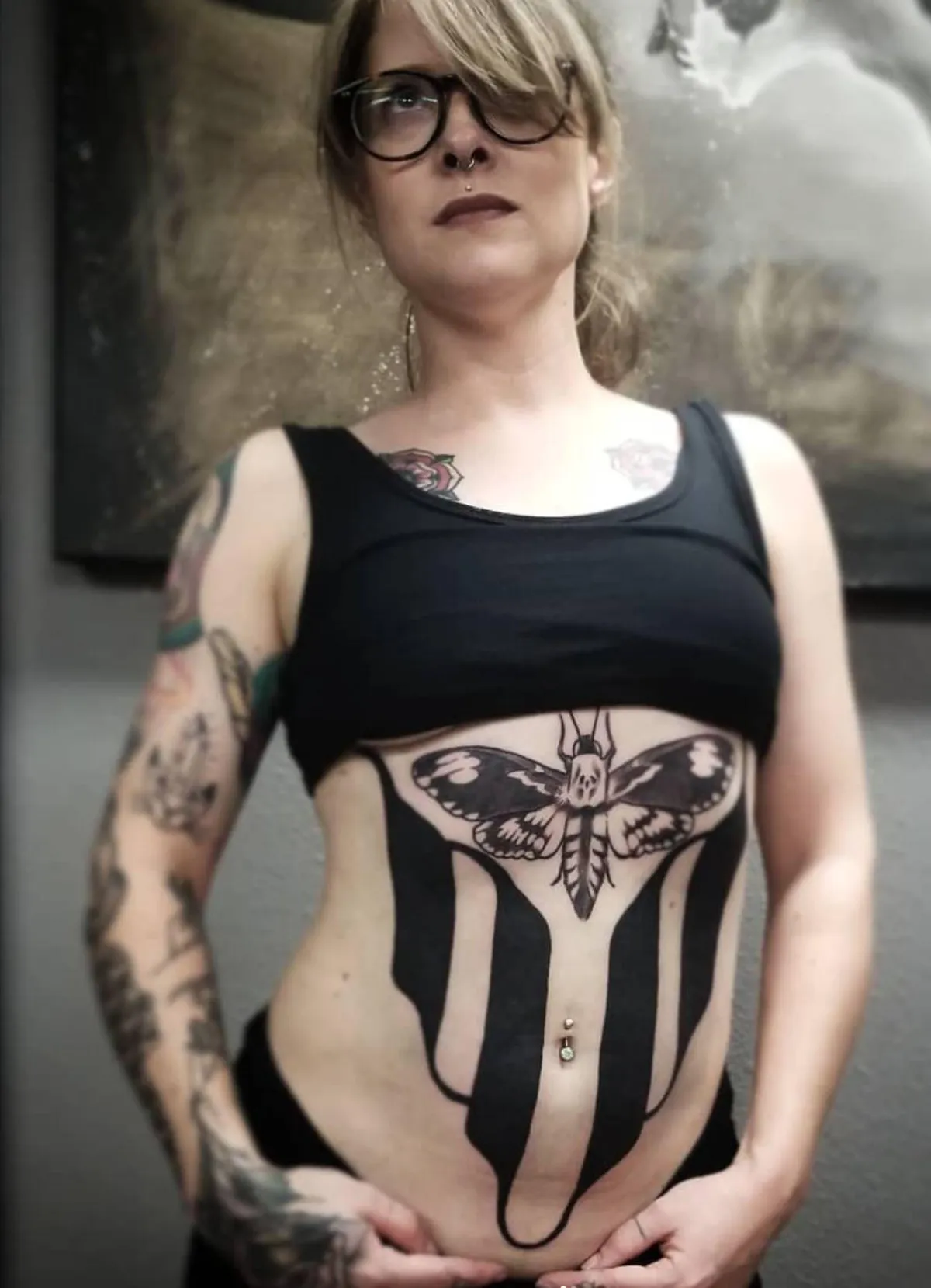 Large torso blackwork tattoo with death's head moth and symmetrical geometry by Mickey Schlick