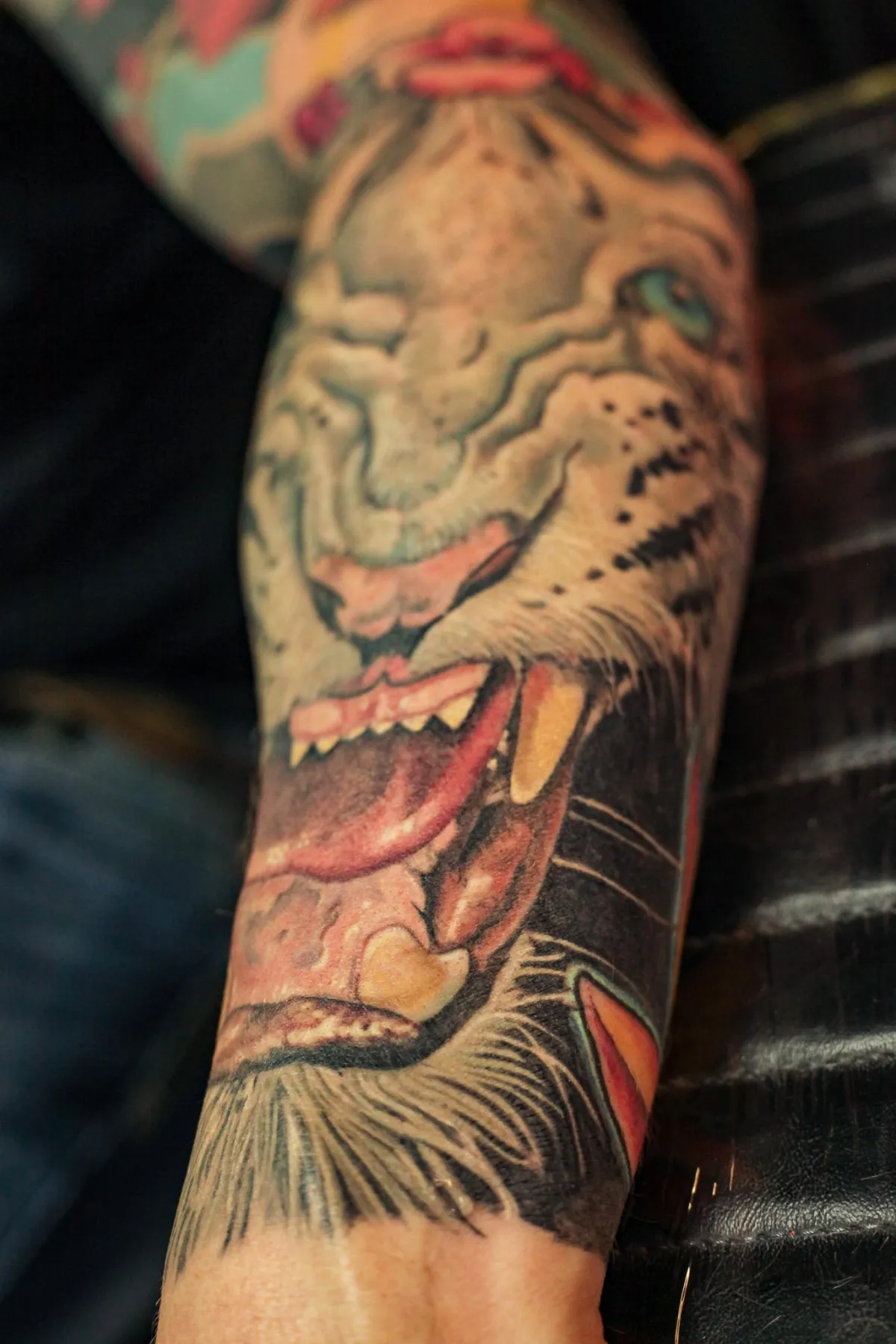 Surreal color tattoo combining an animal skull and open mouthed predator by Mickey Schlick