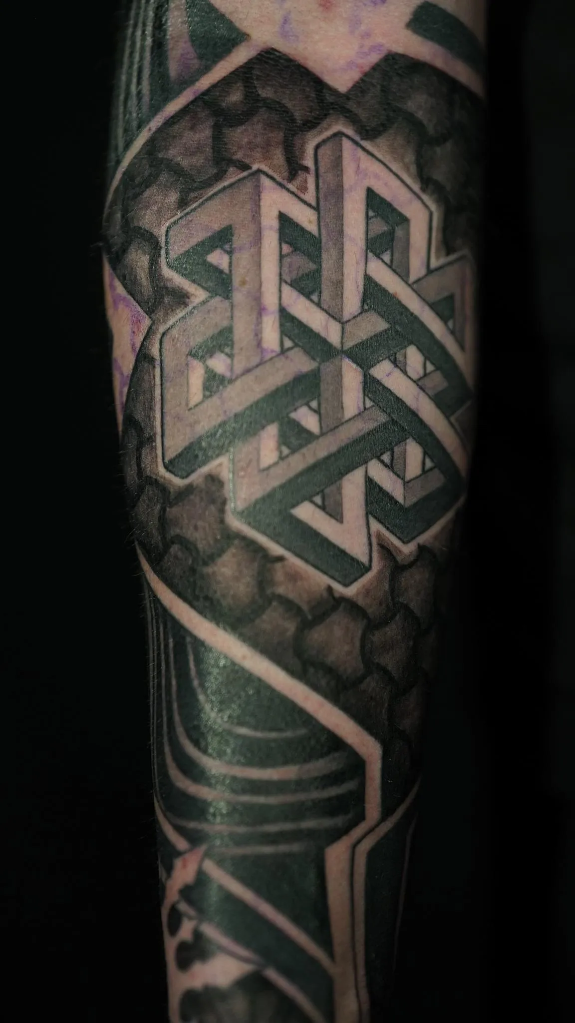 Geometric blackwork tattoo with interlocking impossible forms by Mickey Schlick in Missoula Montana