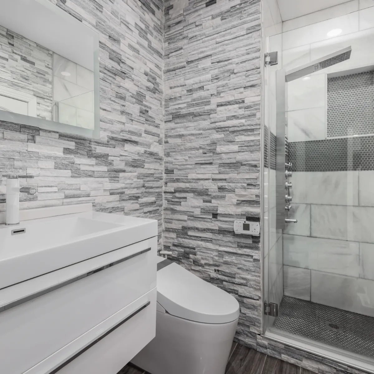 Fort Worth bathroom renovation with tiled walk-in shower, modern vanity, and sleek gray accent walls.