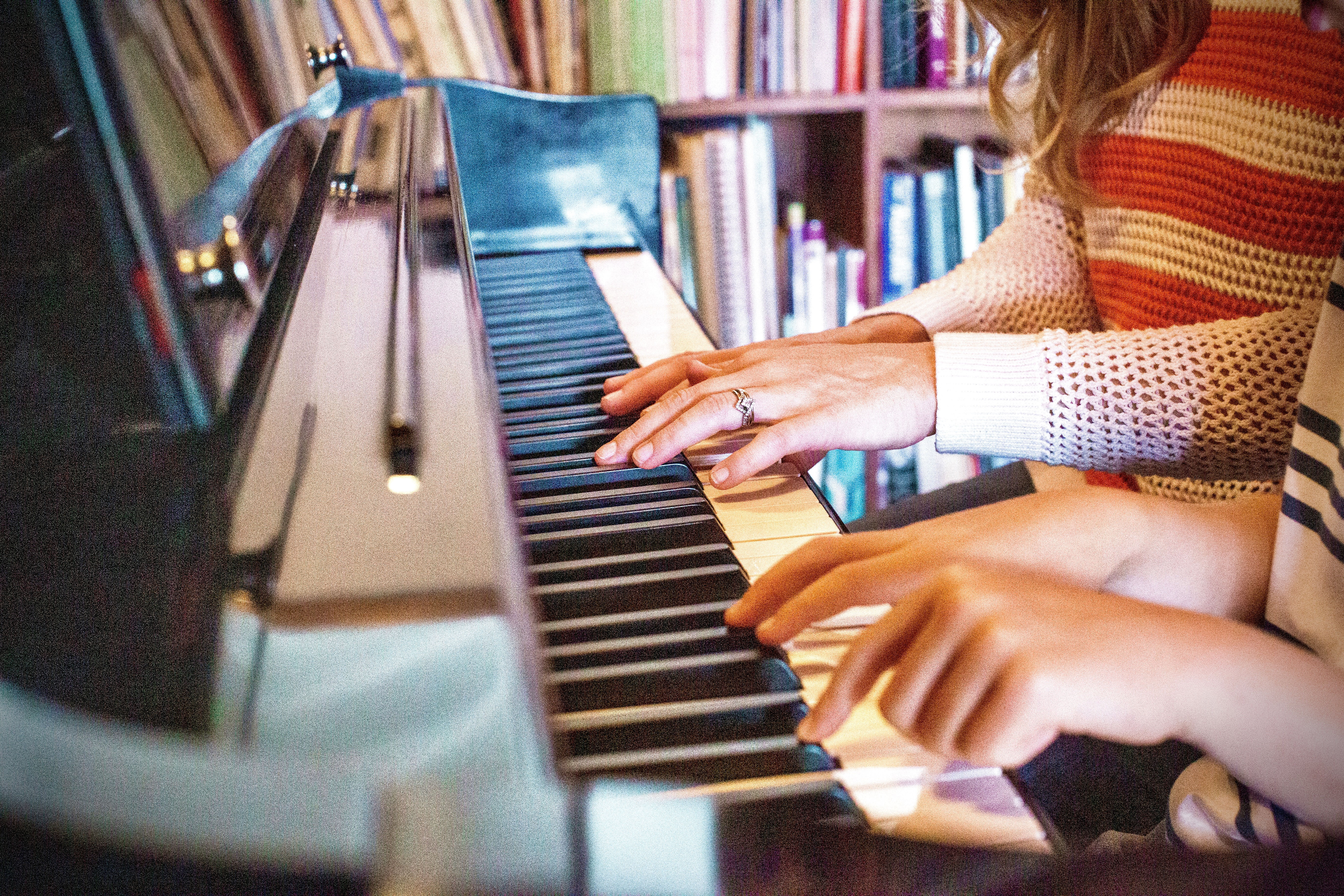 Adult and Child Playing Piano Together