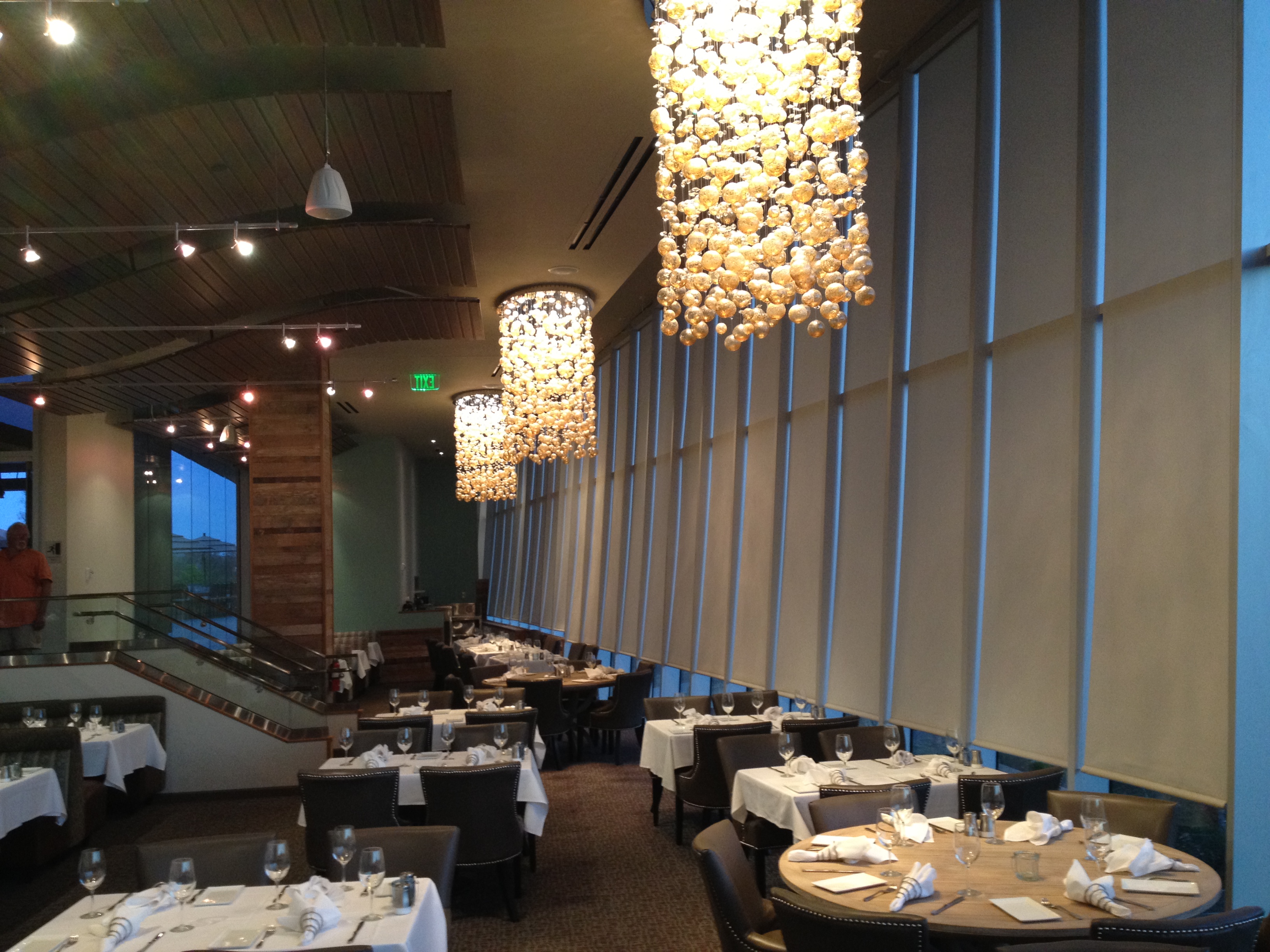 Smart motorized roller shades installed in a modern Thousand Oaks dining space