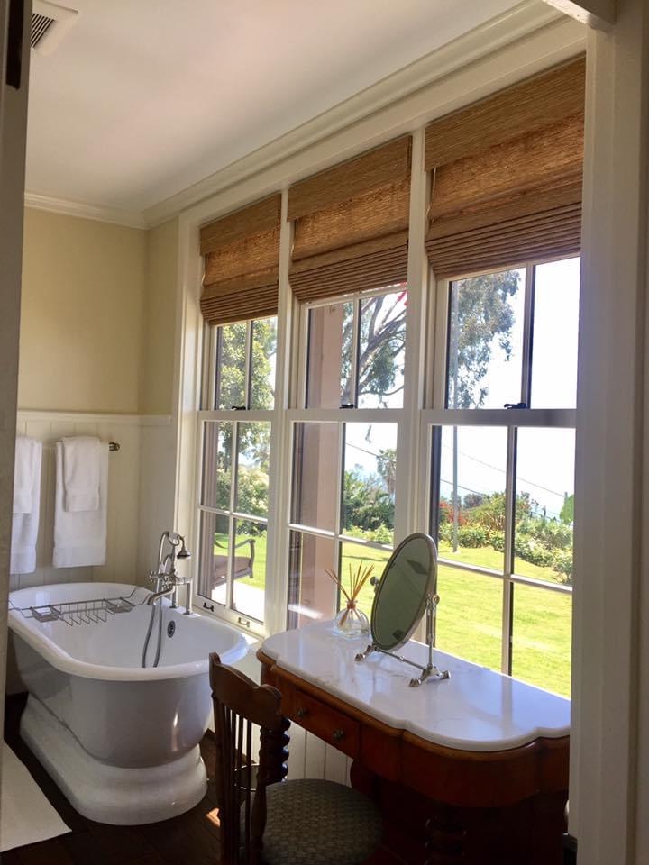 Woven window shades designed for a luxury Camarillo bathroom