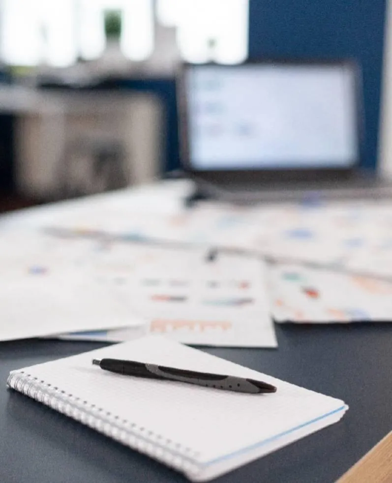 A warm, inviting digital illustration of a diverse Georgia family sitting together at a kitchen table, reviewing documents with gentle smiles. Sunlight streams through a window, creating a hopeful atmosphere. The background is a soft blend of blues and neutrals, evoking calm and trust. No legal or financial symbols are present.