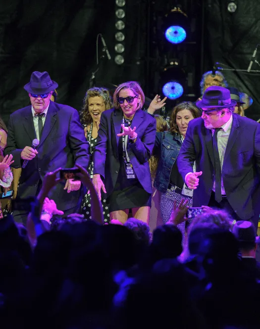 Photo of Michelle Cameron Coulter on stage wit The Blues Bothers (Dan Aykroyd and Jim Belushi)