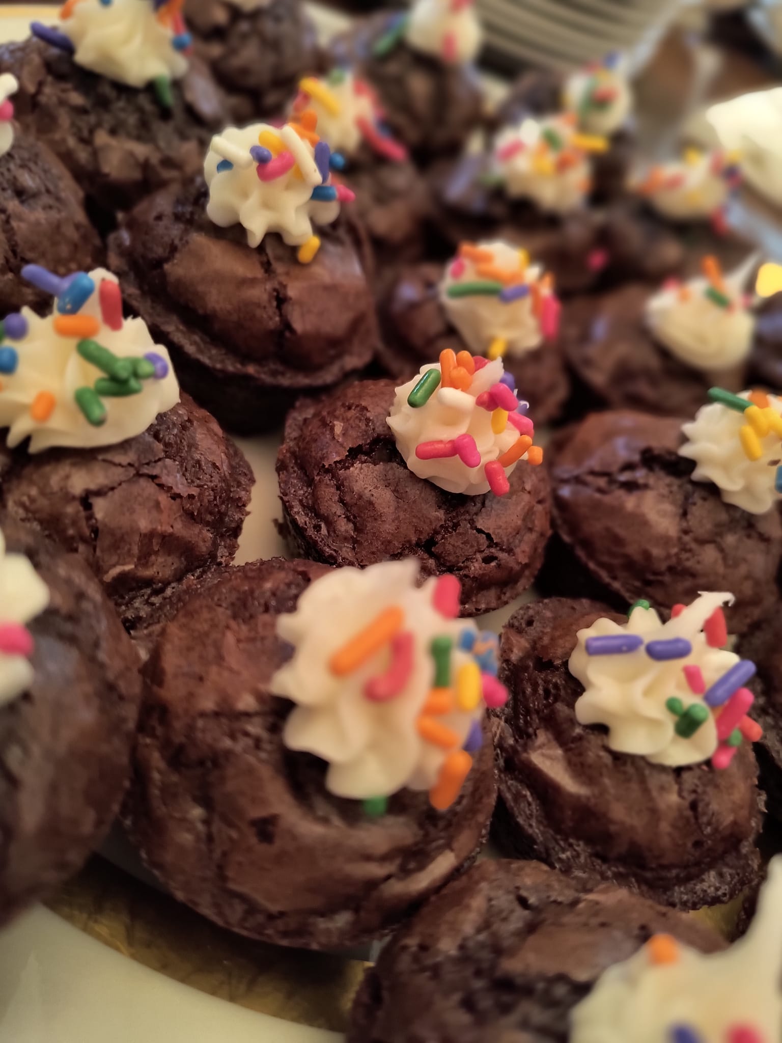 Homemade chocolate brownies with frosting and rainbow sprinkles by Foodie Call bakery desserts