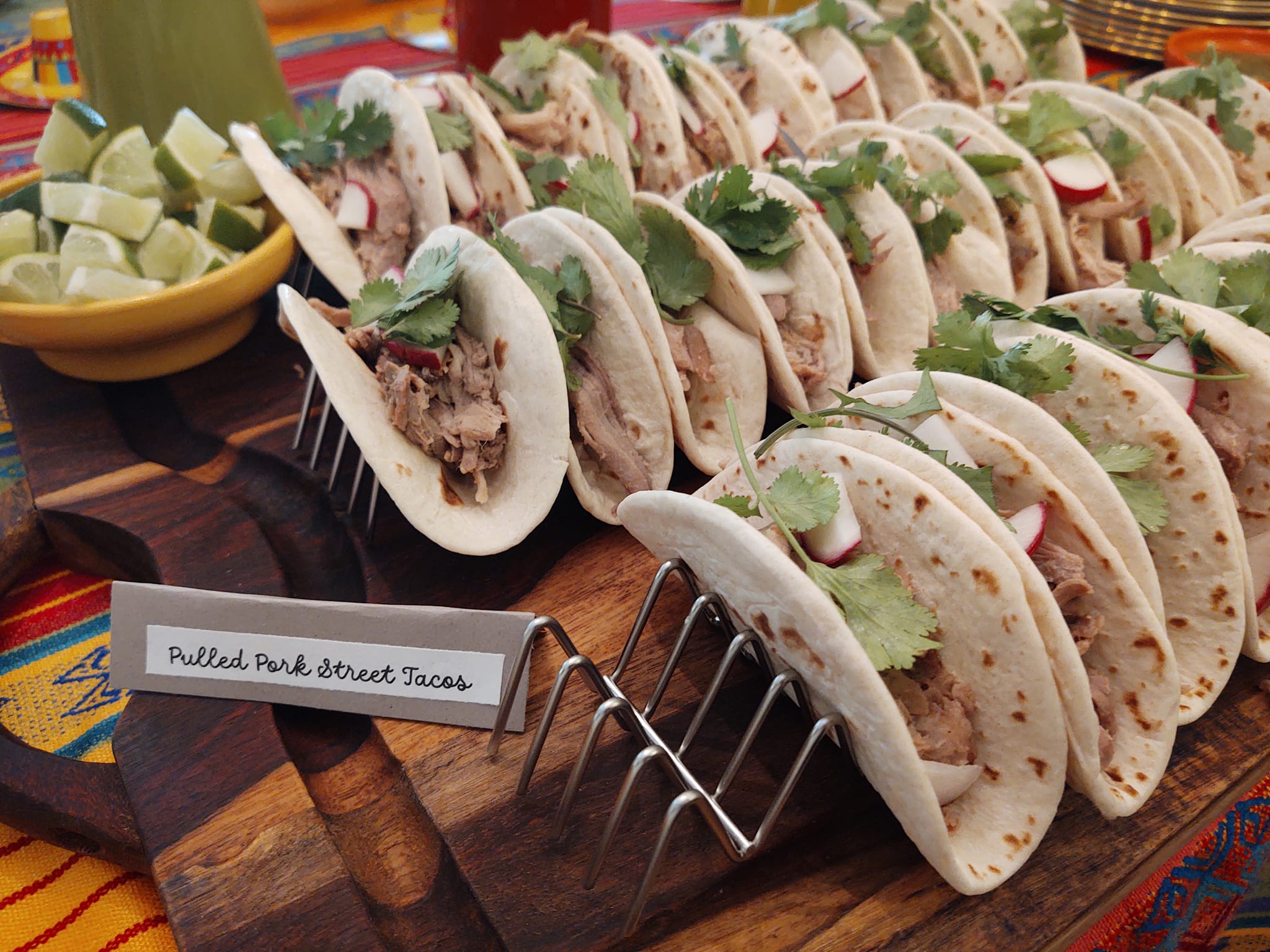 Street-style taco platter with lime wedges and fresh toppings catered by Foodie Call