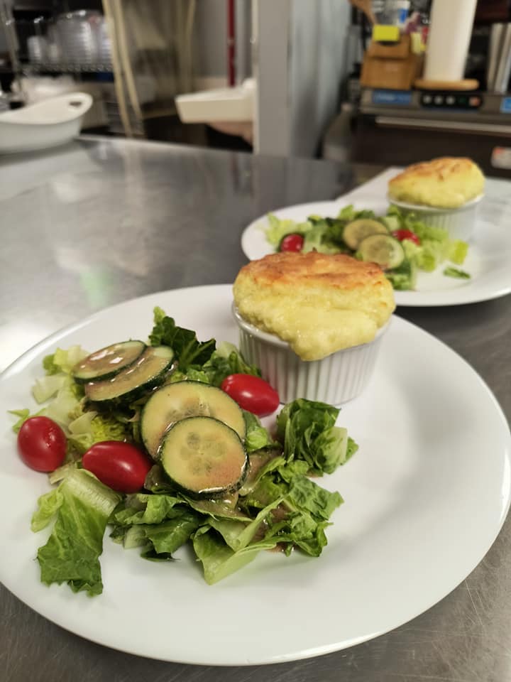 Hands-on cooking class meal presentation with fresh salad and baked soufflé by Foodie Call culinary experiences