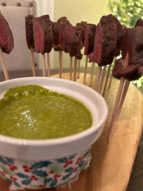 Gourmet steak skewers with herb dipping sauce served at a Foodie Call catering event