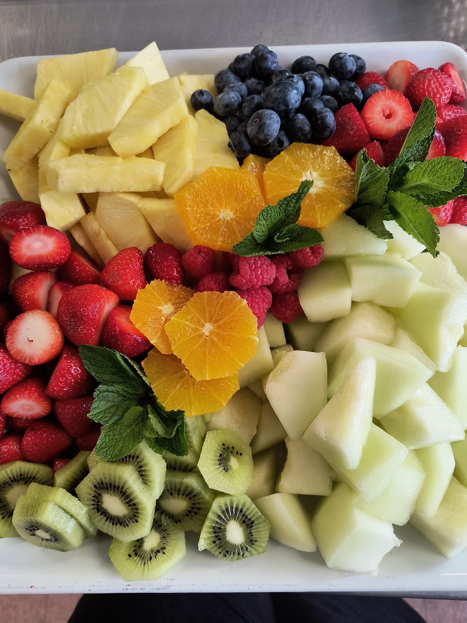Fresh seasonal fruit platter with strawberries, melon, and citrus arranged by Foodie Call catering