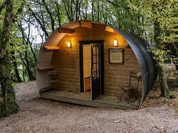 Building entrance at night with cars parked outside.