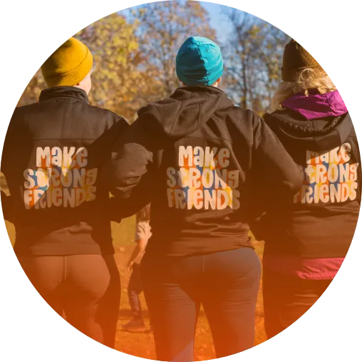 Three people with hoodies that read "Make Strong Friends" on the back.