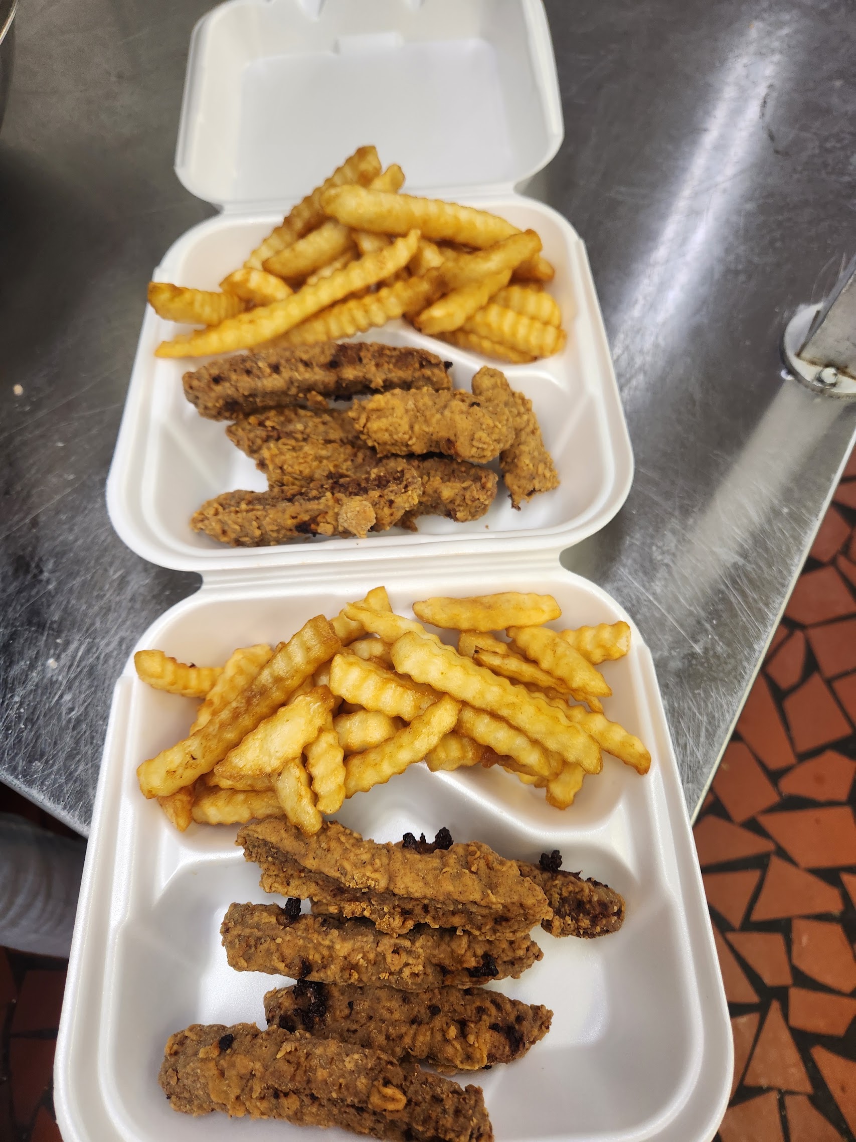 Chicken tenders and crinkle fries in takeout containers