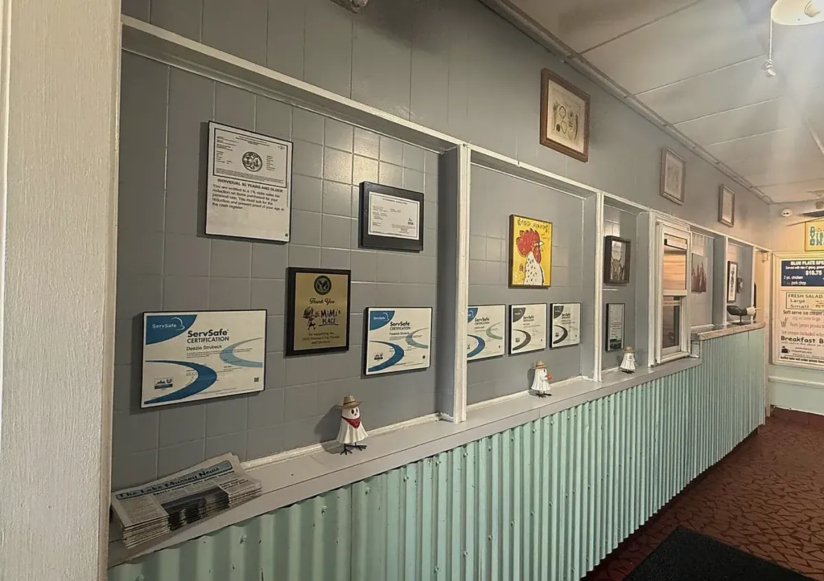Certificates, newspaper article and community recognition displayed inside MiMi’s Place