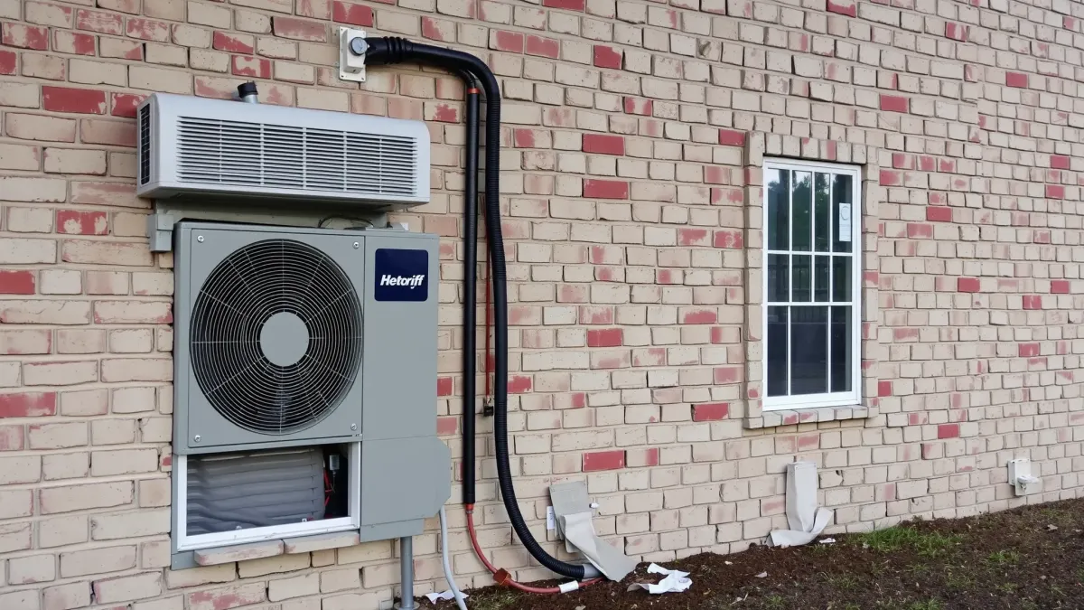 Freshly installed outdoor air conditioning unit outside a modern home in Everman, TX, with a landscaped yard and blue sky.