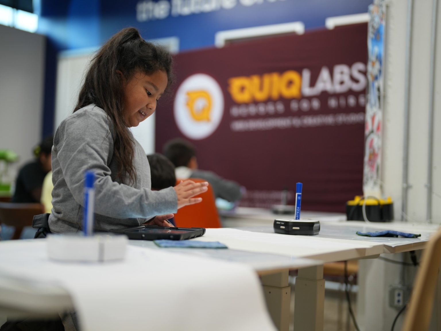 Scientist in lab coat conducts experiment with test tubes.