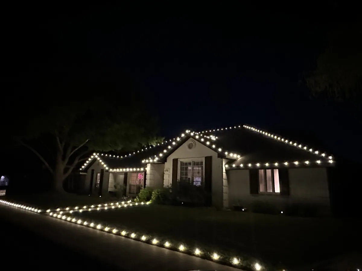 a white brick wall with a lamp on it