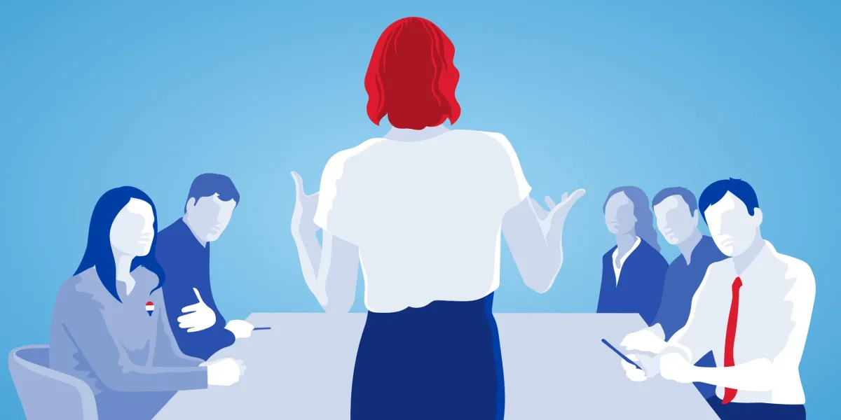 A young woman sits at a desk in an office.