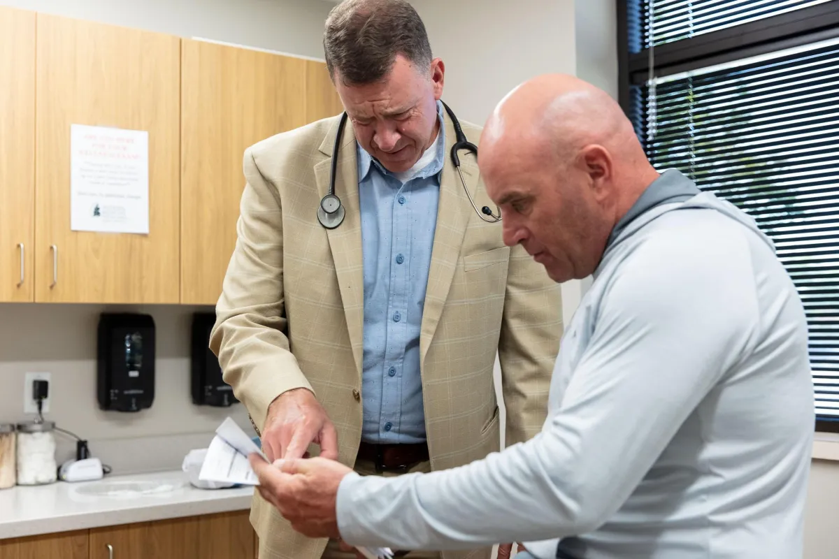 Dr. Sharp speaking with a patient about his test results. 