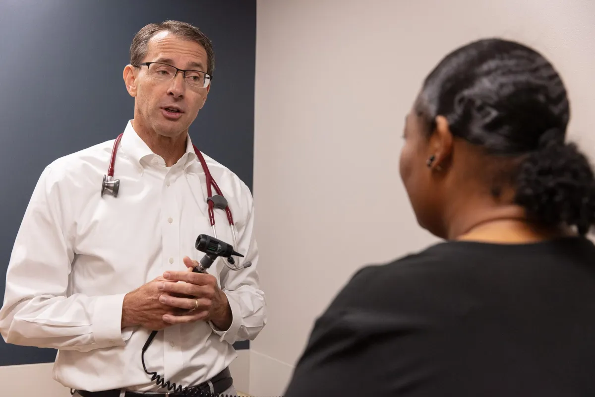 Dr David Keller speaking with a patient during office hours.