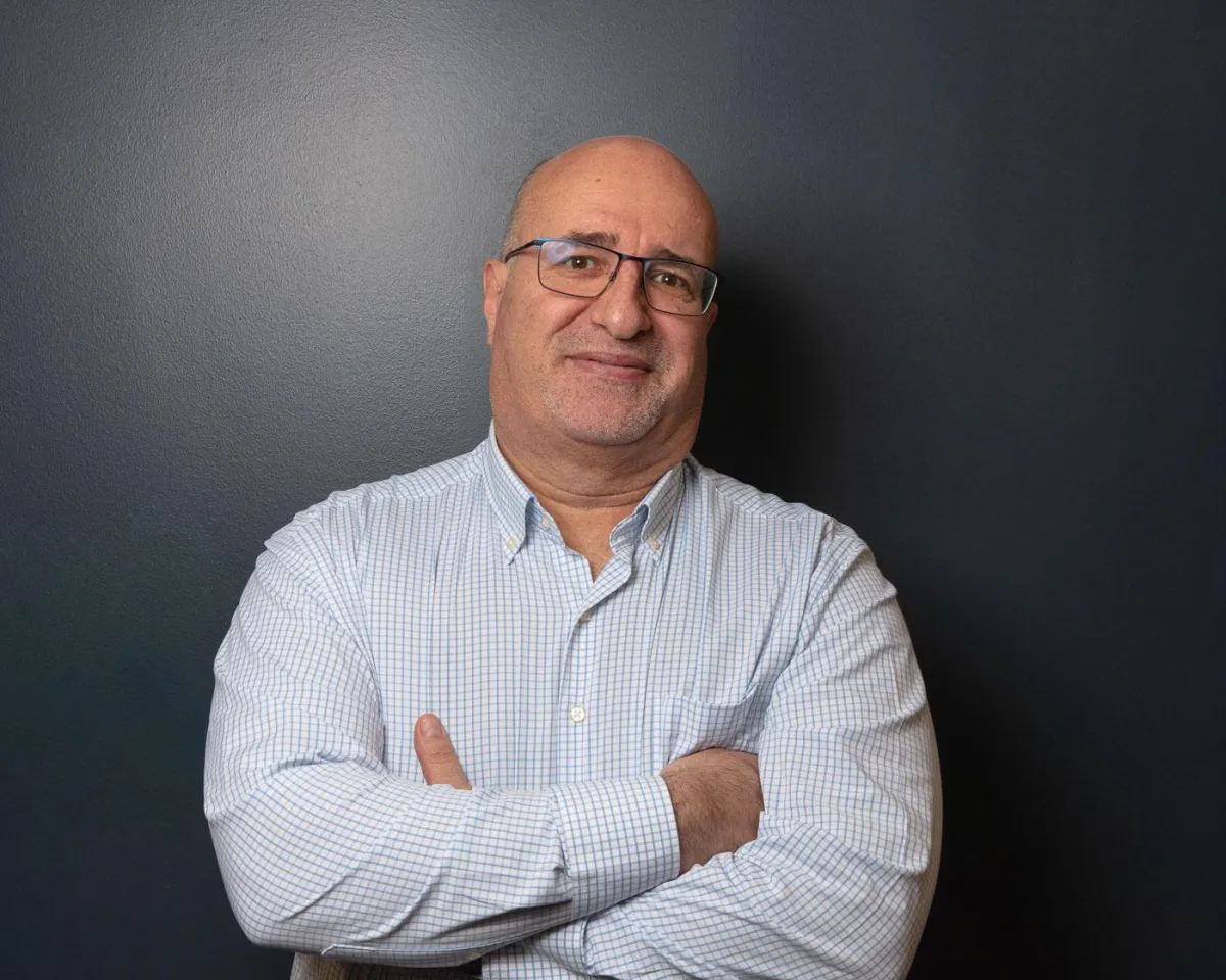 A Portrait of Dr. Maen Haddadin standing in a clinic office in Omaha Nebraska. 