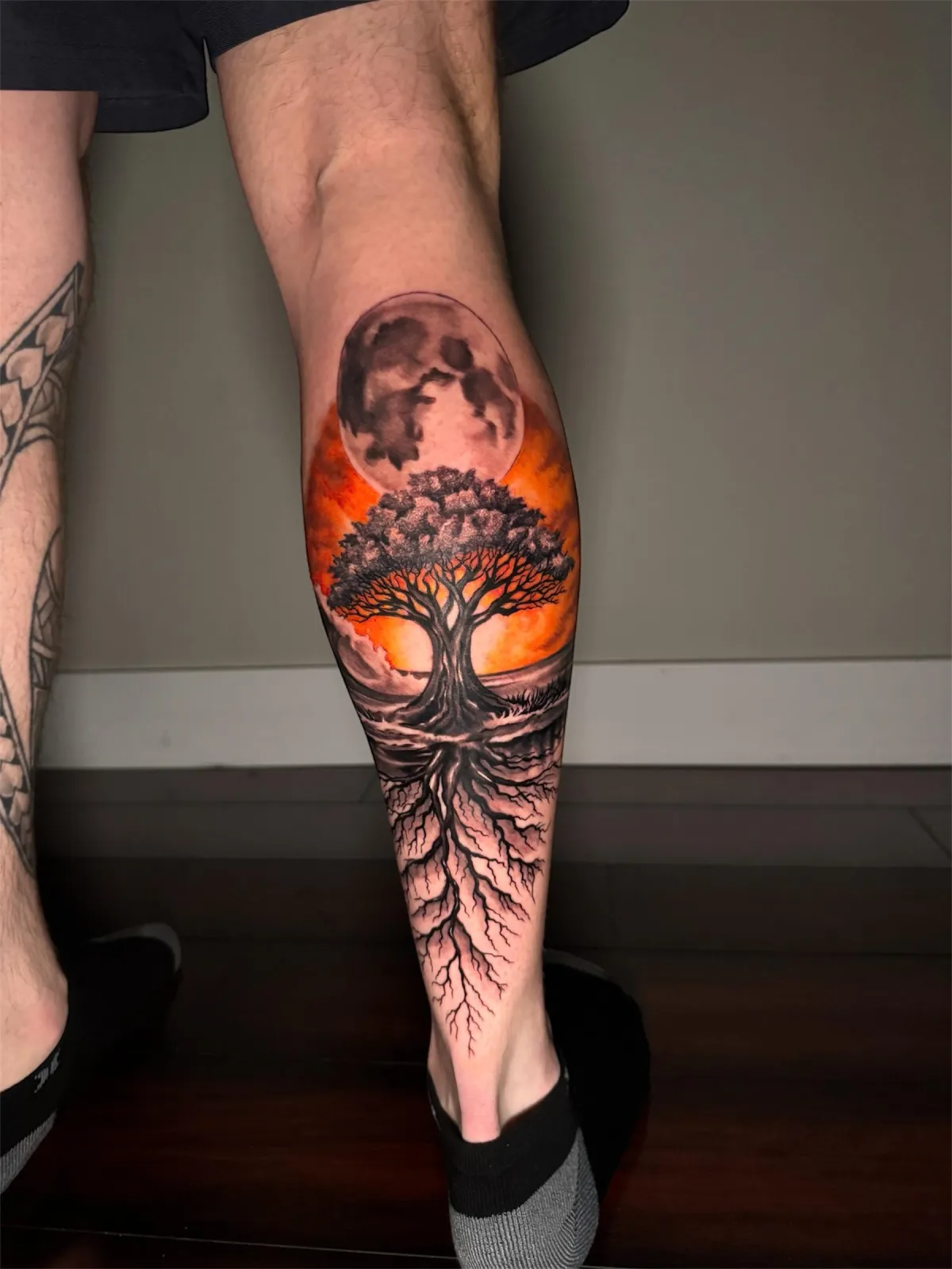 Bold geometric blackwork tattoo on arm