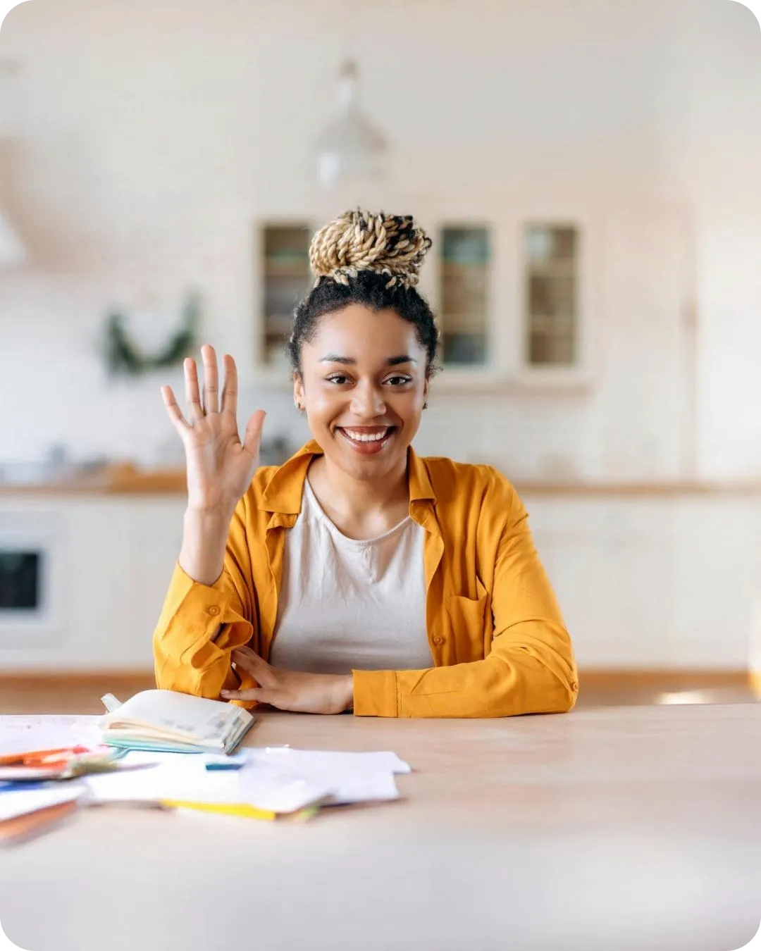 Friendly tutor waving from a home desk, representing Joy Tutoring’s personalised services in Pinelands, Cape Town or online across South Africa.