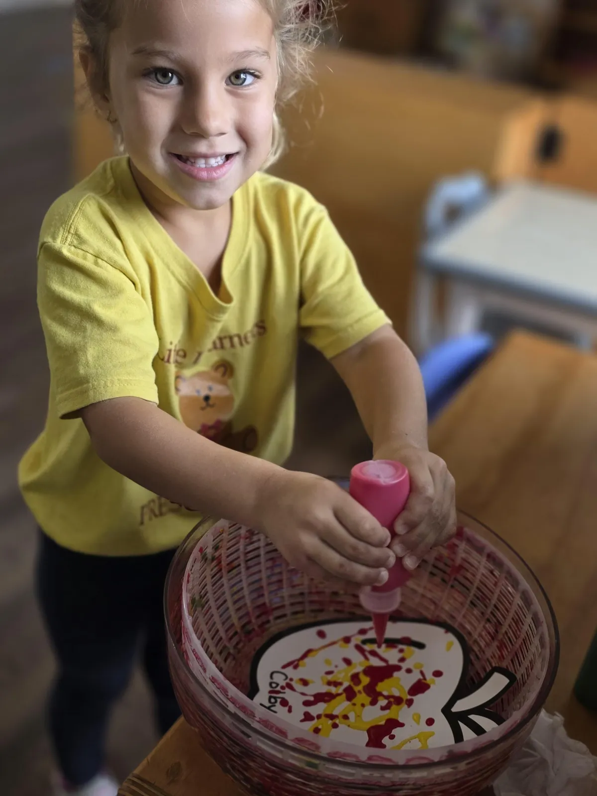 Girl follows directions during arts and crafts time.