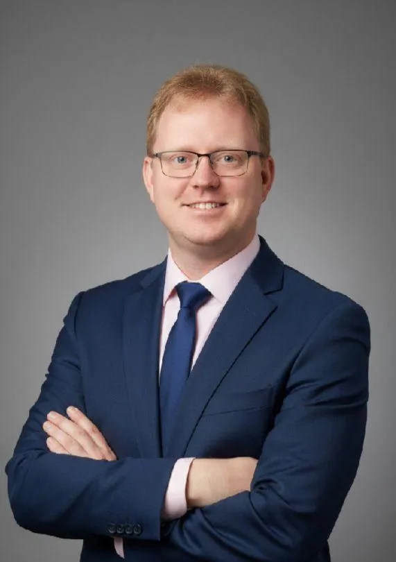 Portrait of Morten Mathisen, Scandinavian male, 40s, business attire, approachable, gold backdrop, 3:2 aspect