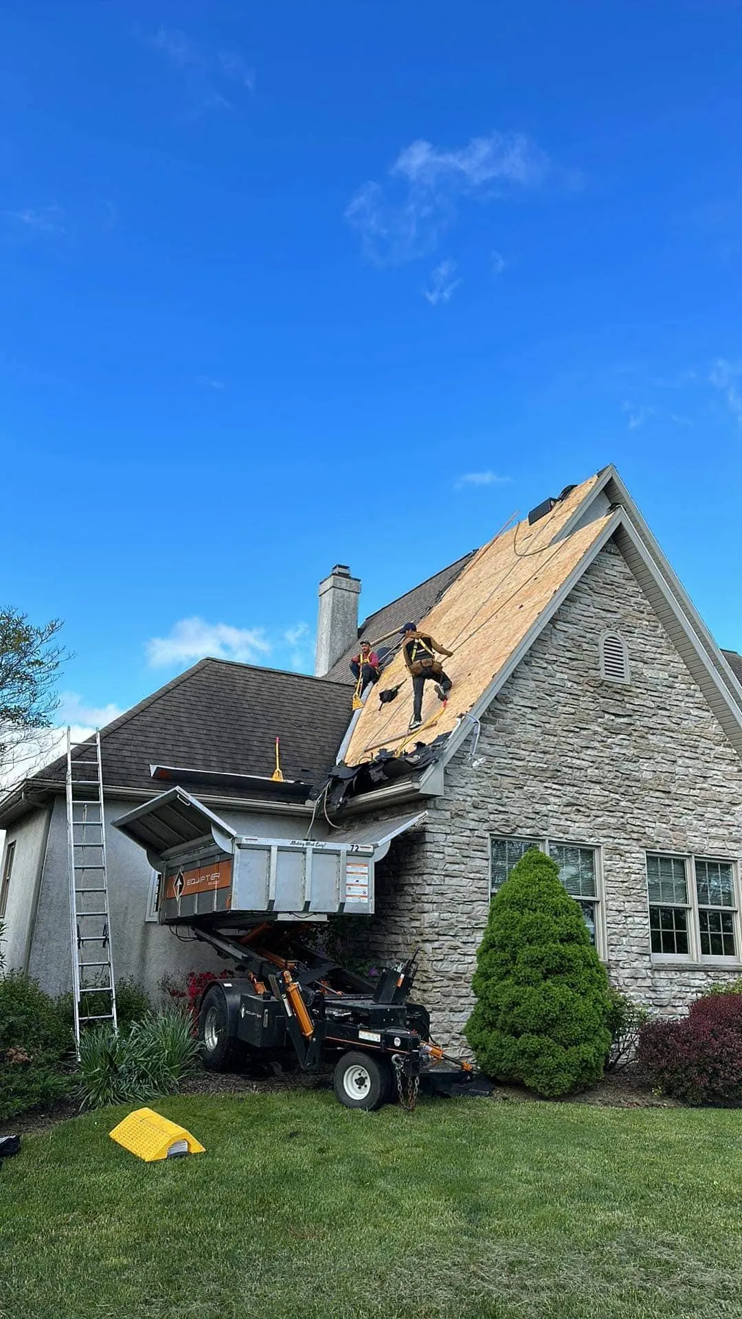 a group of expert roofers doing a roof repair