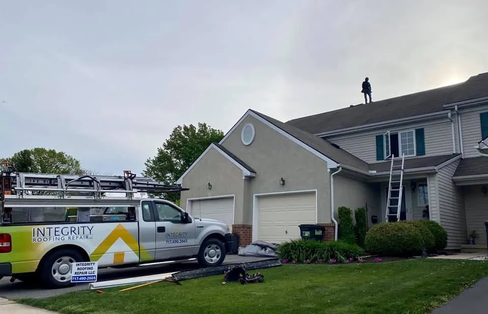 Integrity Roofing Repair truck in front of a house