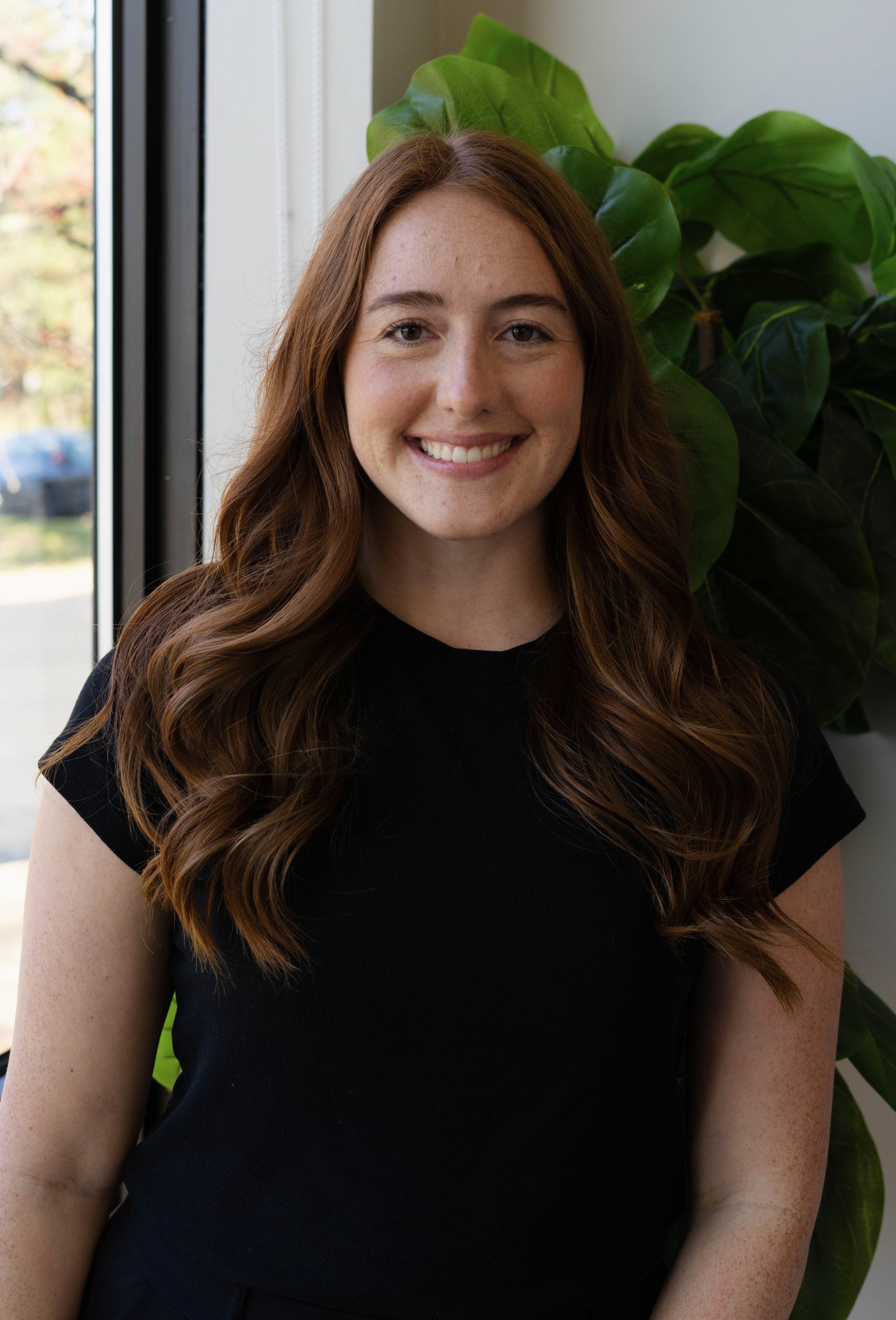 Dr. Kaitlin Schultes, DC, smiling in a professional setting, representing Great Lakes Health and Wellness in Westlake, Ohio, emphasizing her commitment to chiropractic care.