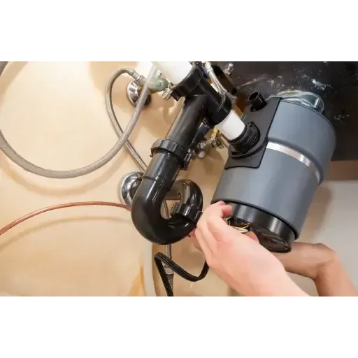 Diagnostic and repair services for a jammed or leaking kitchen garbage disposal unit by Hometown Plumbing.