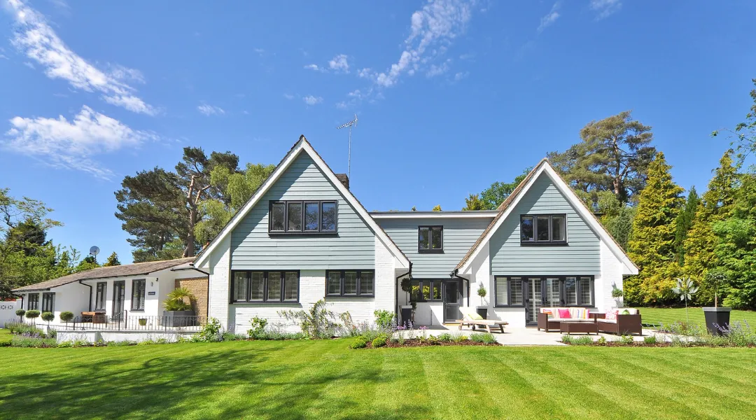 Charming custom suburban home with a spacious front yard, elegant architecture, and a warm, inviting design for comfortable family living.
