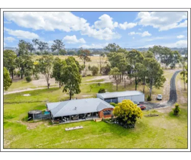 Drone image showing a farm house acreage.