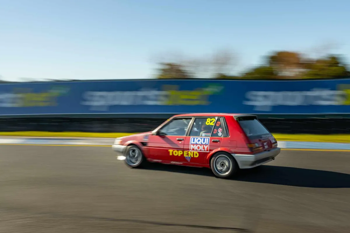 corolla race car on track from rear left