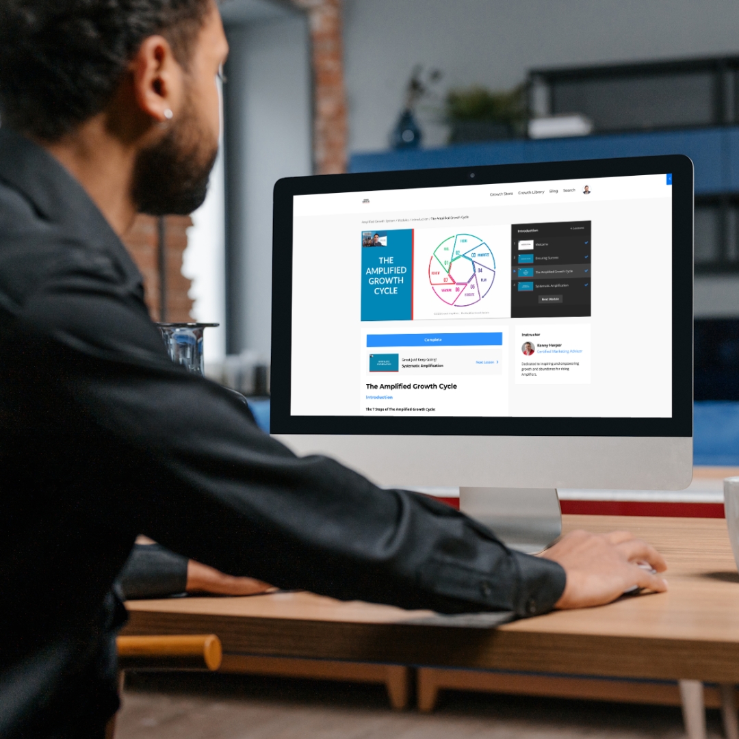 Man looking at the Amplified Growth System on a Laptop