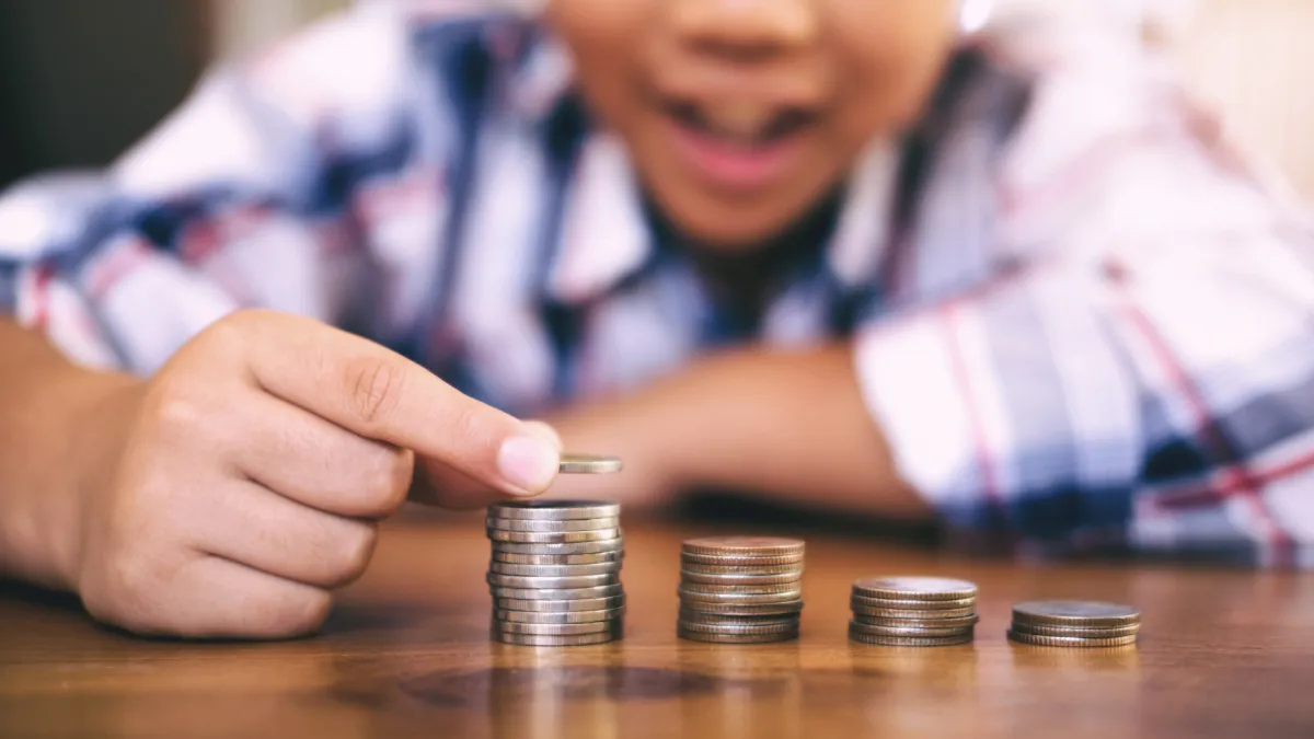 Happy boy stacking coins