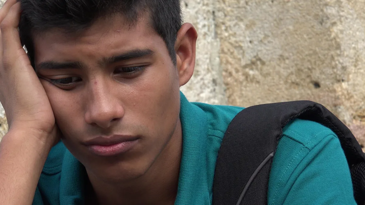 Despondent and sad looking teen boy