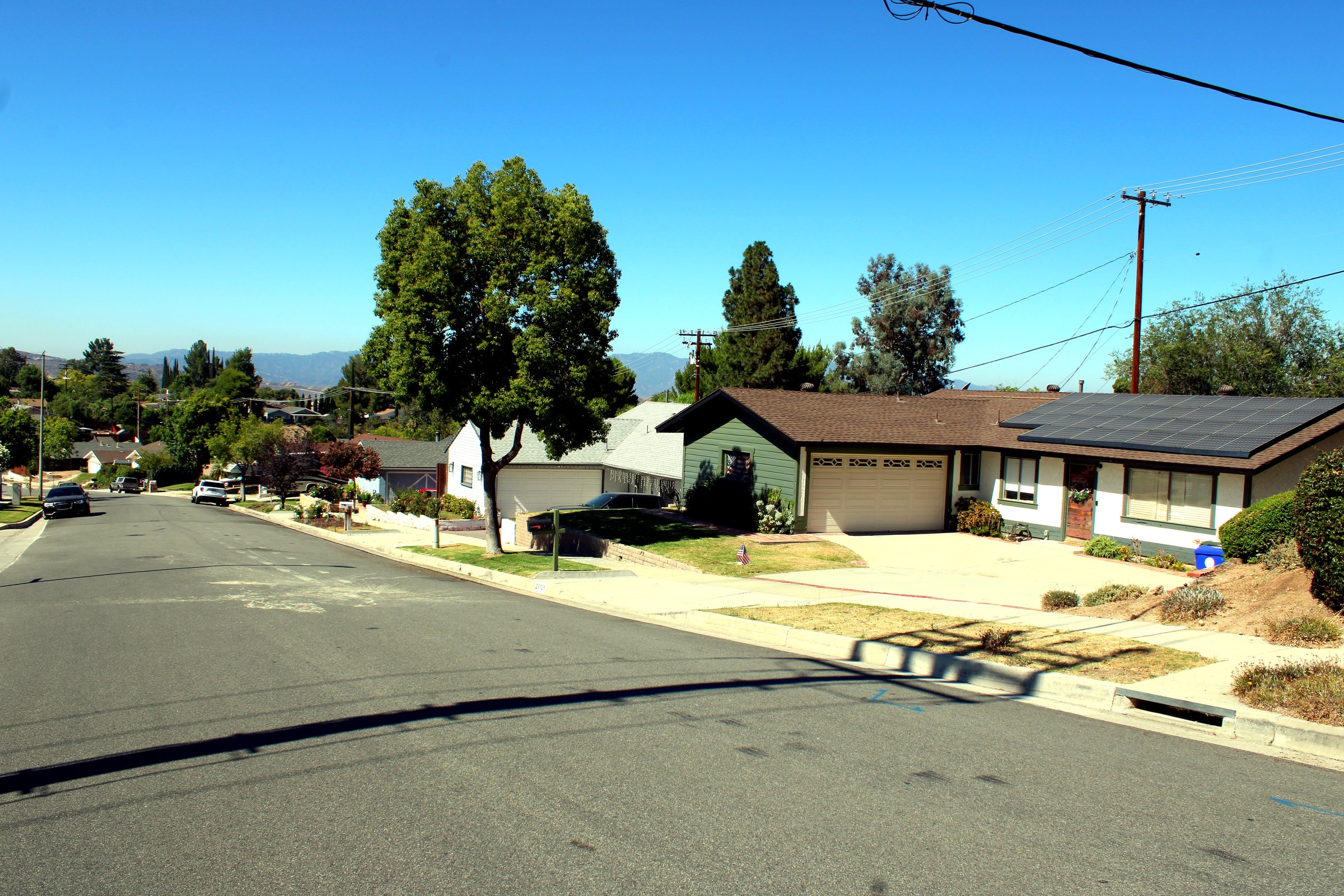 Single-story homes on a hillside residential street in Canyon Country, Santa Clarita