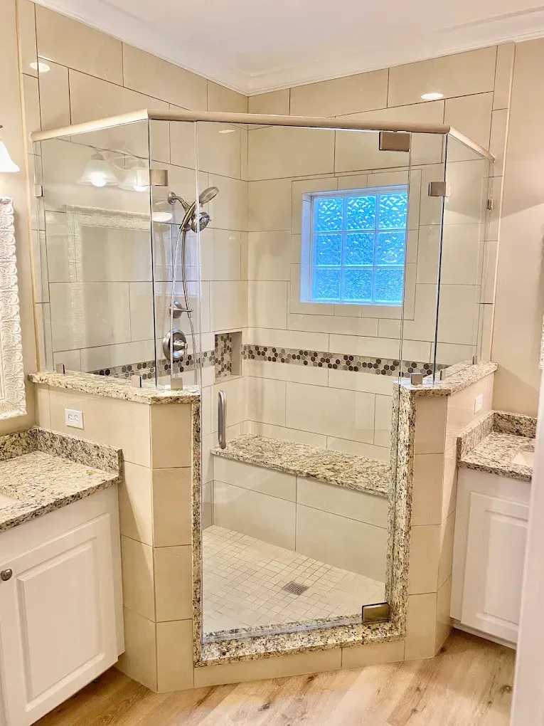 A beautifully renovated bathroom with modern fixtures, glass shower, and elegant tilework, photographed in natural light, showcasing the transformation achieved by a remodeling business using the agency’s lead generation service.