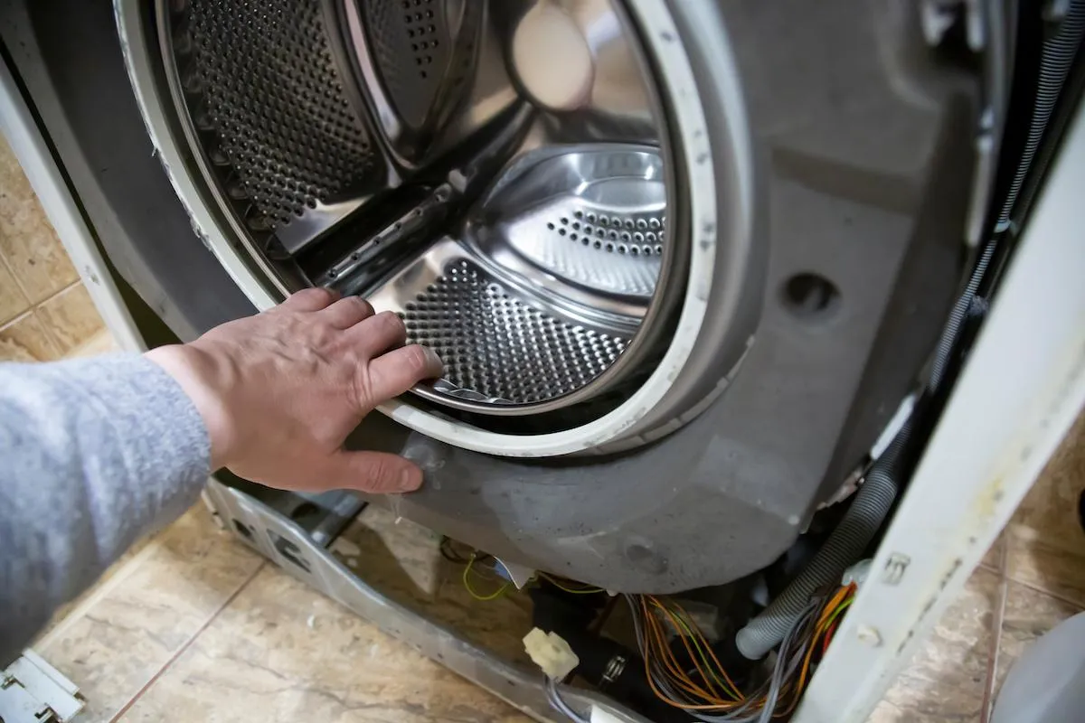 Dryer repair technician inspecting heating unit