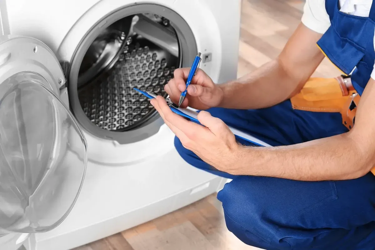 Dryer repair technician checking internal components