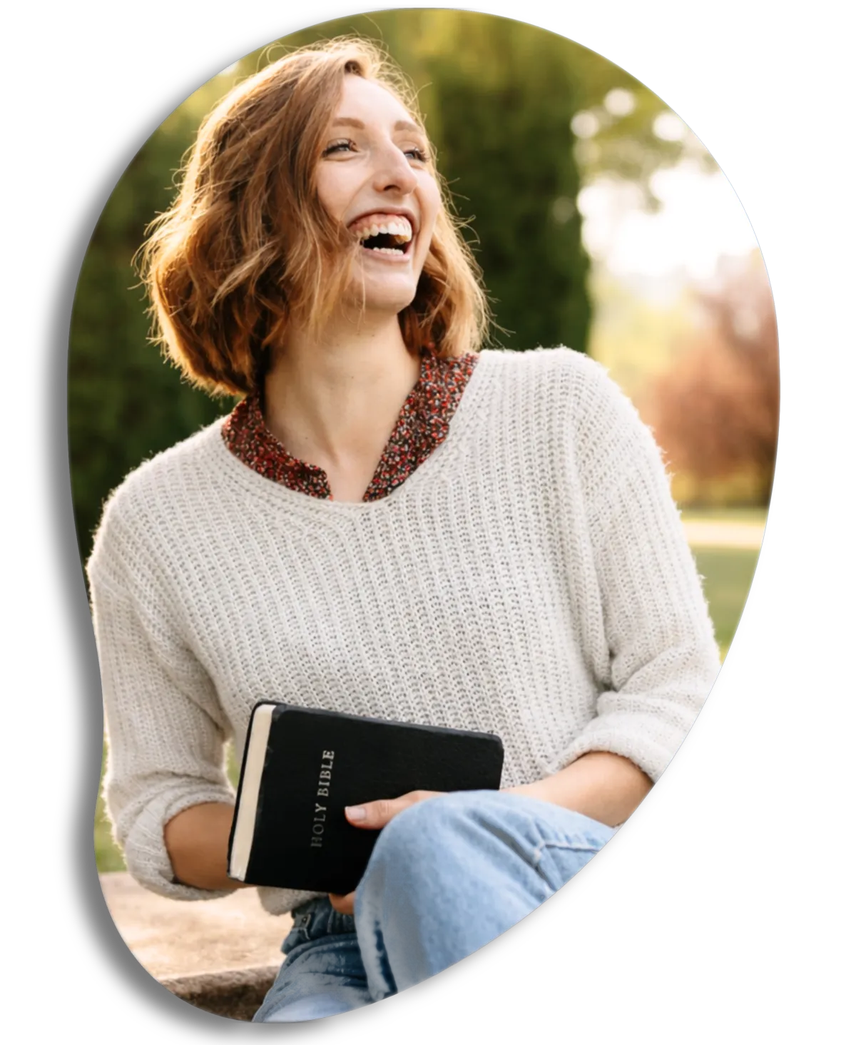 Woman filled with joy carrying the bible because she understands spiritual warfare is not scary.