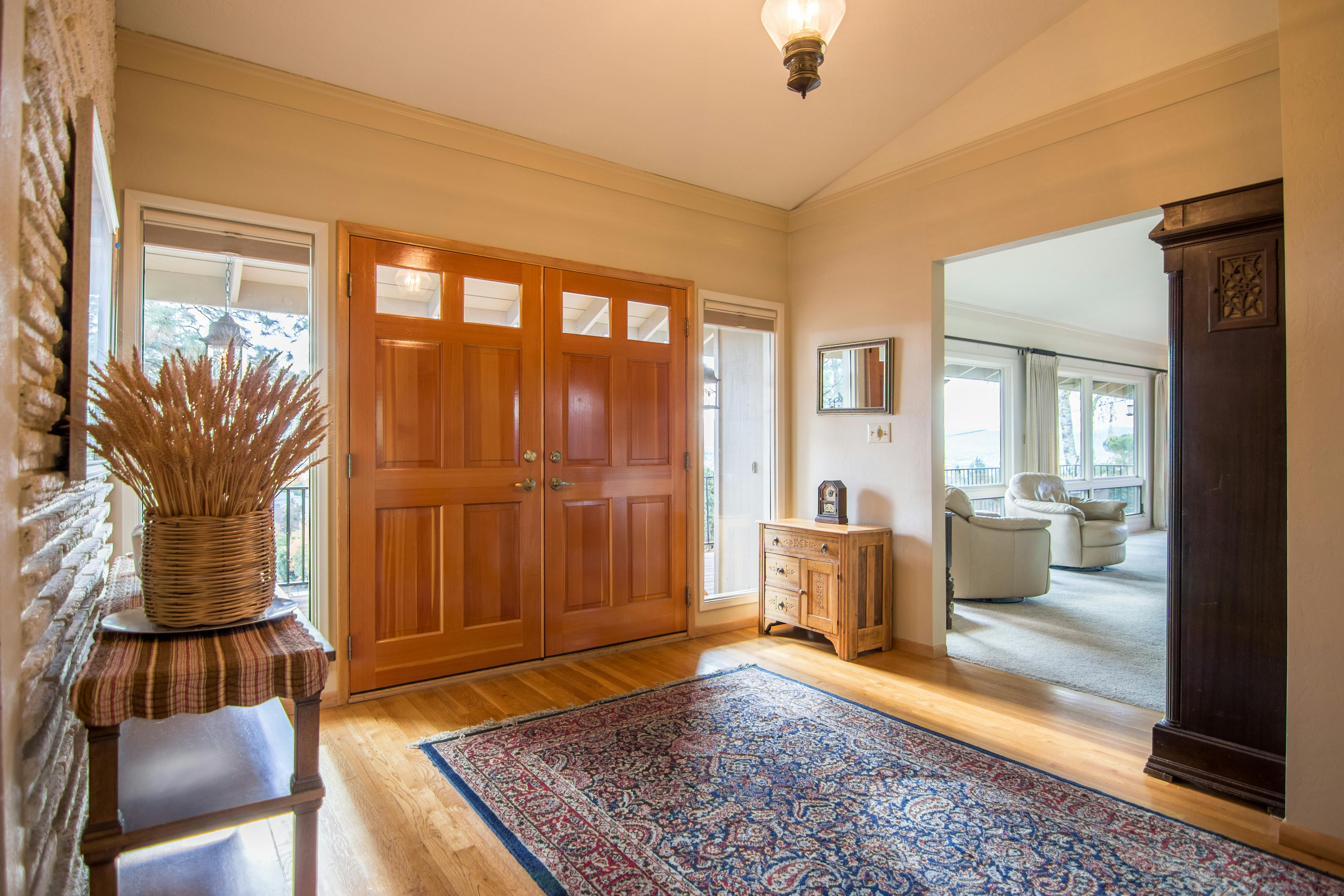 Gainesville FL home interior showing foyer with double entry doors and a view into the living room