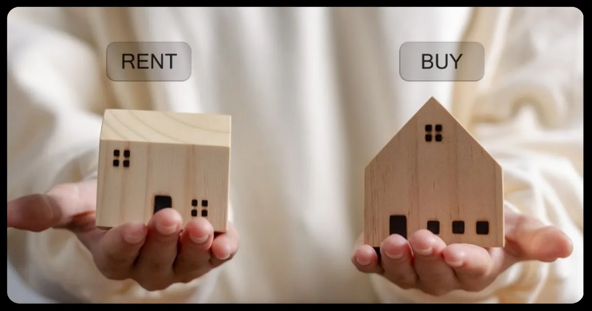 two hands each holding a small wooden home weighing rent vs buying