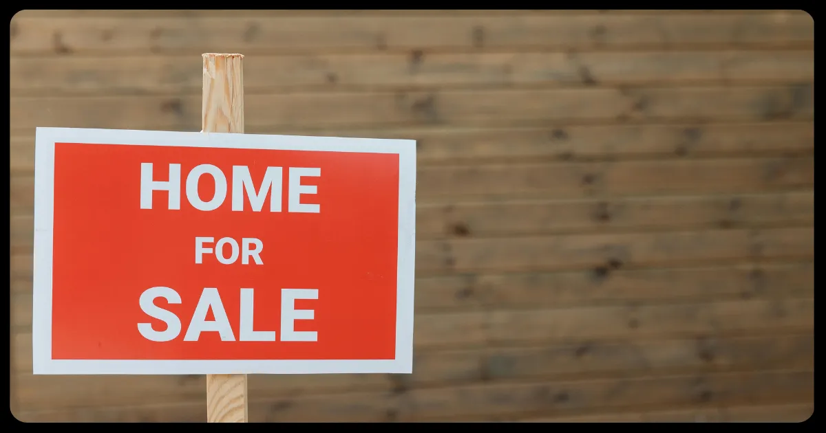 simple red and white home for sale sign on a wooden stick