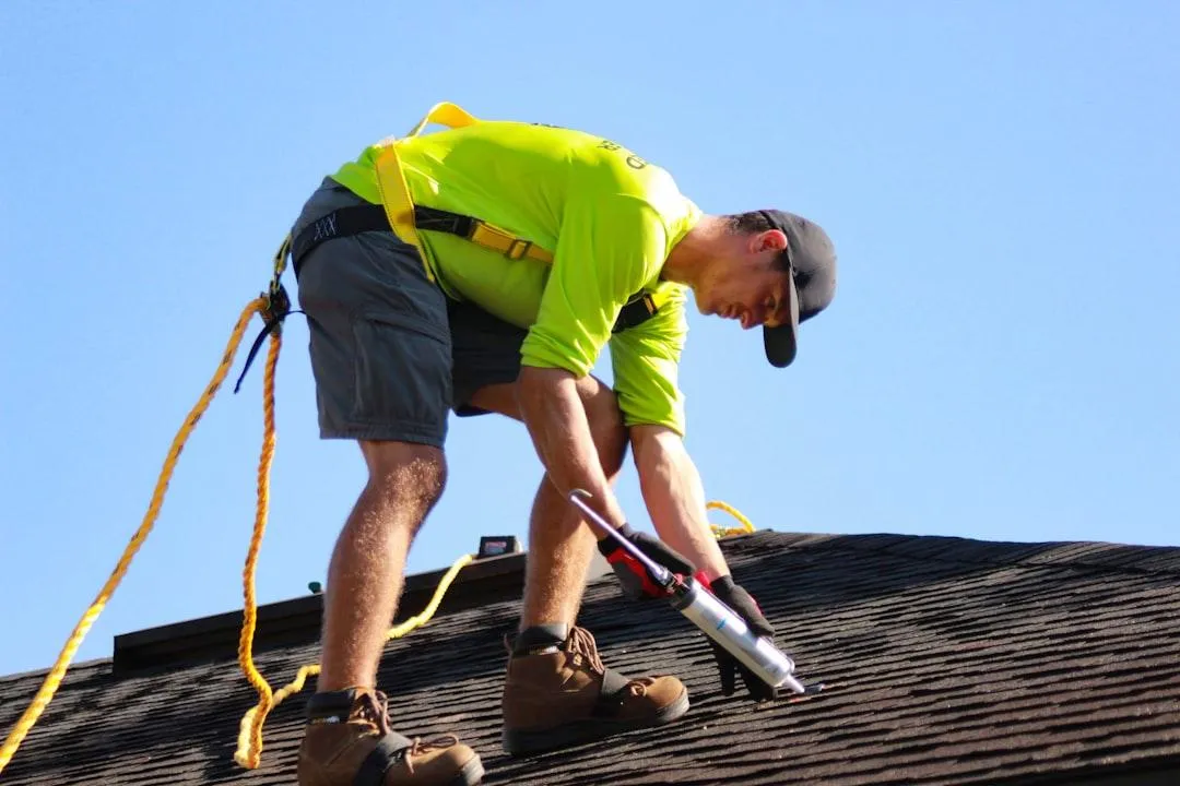 roofing contractor servicing a roof